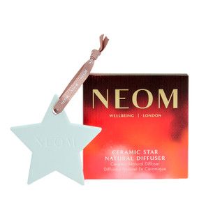 Neom Ceramic Star Natural Diffuser—a white ceramic star & a striped red and pink cardboard box