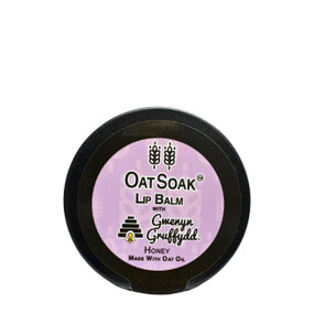 Oat Soak x Gwenyn Gruffydd Honey Lip Balm 10 ml in a black tin with purple label; formulated to treat very dry, chapped lips, this soothing and deeply hydrating lip balm provides intense nourishment and long-lasting moisture